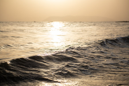 Sea. Beautiful golden sunset on the Mediterranean coast with unusual lighting through the air hazeの写真素材