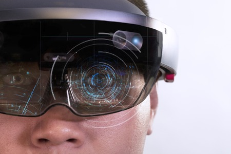 Portrait of young man with 3D virtual reality eye wear glasses hololens | Eye focus magic matrix on white backgroundの写真素材