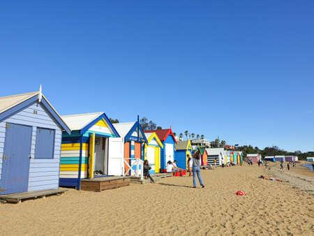 Colourful bathing boxes at Brighton Beach with tourism on vacation under sunlight, Melbourne, Australia, 29 February 2020.のeditorial素材