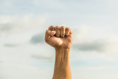 fist with sky background hand sign languageの写真素材