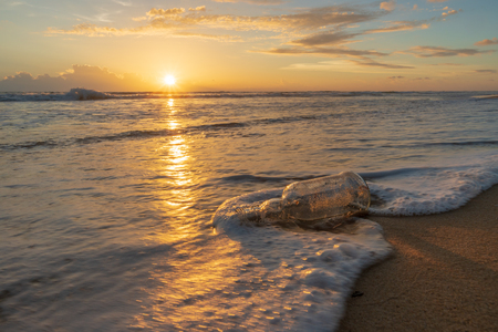 Glass bottle with beatiful beach sunset landscapeの写真素材