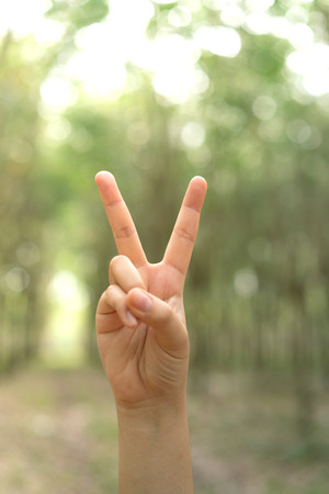Two fingers with blur background body language sign V signの写真素材