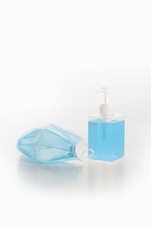 Hygienic mask and a bottle of alcohol based hand sanitizer gel on white background protect from virus covid 19 n95 pollutionの写真素材