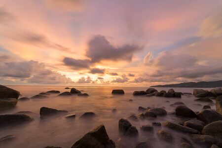 landscape long exposure Sunset beach and sea rockの写真素材
