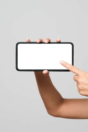 Smartphone mockup. New frameless smartphone mockup with white screen. Isolated on white background. Based on high-quality studio shot. Smartphone frameless design conceptの写真素材