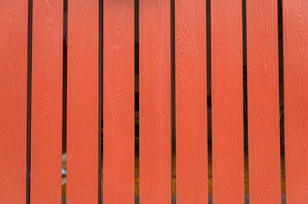 coral, orange old wooden fence. wood palisade background. planks textureの写真素材