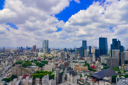 Beautiful city skyline of Downtown Tokyo, with the famous landmark Tokyo Tower standing tall among crowded skyscrapers under blue sunny sky in Tokyo, Japan. Aerial view of busy Tokyo City. 10 October 2017のeditorial素材