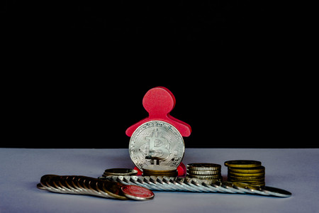 Silver Bitcoin with different coins: penny, dime, quarterの写真素材