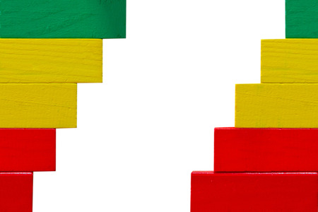 Concept of building success foundation, Arrangement colorful puzzle wooden blocks left and right in the shape of a staircase isolated white backgroundの写真素材