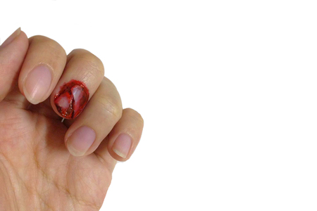 Tearing nail with blood fall from accident isolated white backgroundの写真素材