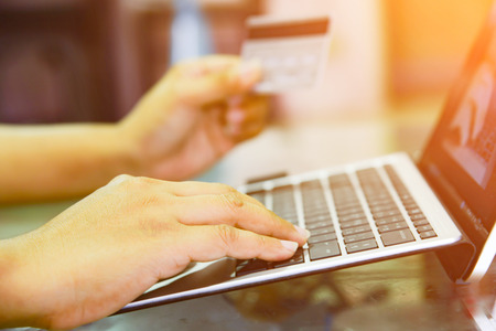Hands holding credit card and using laptop. Online shopping.の写真素材