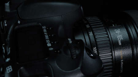 TOMSK, RUSSIA - March 21, 2020: Canon 7D camera on black background with 24-105 lense