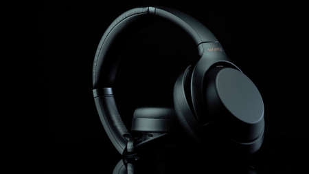 TOMSK, RUSSIA - April 12, 2020: Sony WH-1000XM3 Noise Canceling Wireless Headphones on a rotation platform black backgroundのeditorial素材