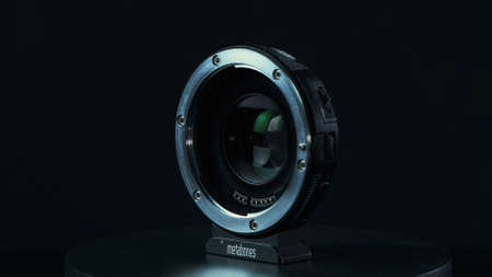 TOMSK, RUSSIA - May 28, 2020: Metabones speedbooster 0.71 ultra standing on a black turntable, Micro...