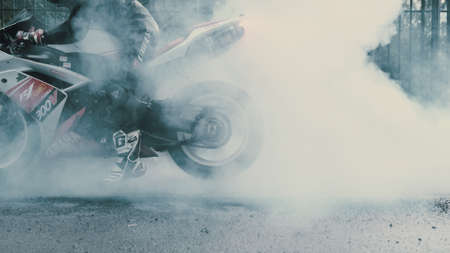 TOMSK, RUSSIA - May 16, 2020: Yamaha R1 in stickers and a pilot in overalls makes a burnout, a lot of smokeのeditorial素材
