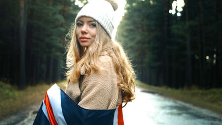 The girl holds the flag of United Kingdom in hands. Portrait shoot