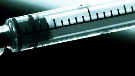 A surgical syringe injects the virus. Infected blood. Macro frameの写真素材