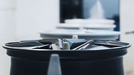 Black cast wheel on conveyor belt before paintingの写真素材