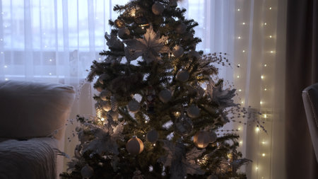 Christmas tree is beautifully lit with garlands