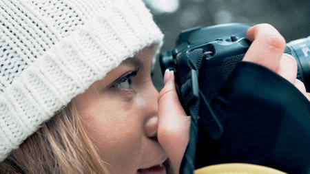 The face of the girl from the side leans the camera to the face in the winter in the forestの写真素材