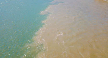 Two rivers collide into one with amazing mountain view. Drone footageの写真素材