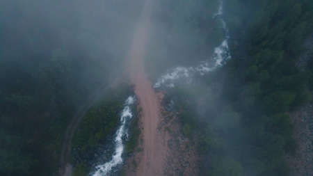 The fog over the hills is approaching. Drone footageの写真素材
