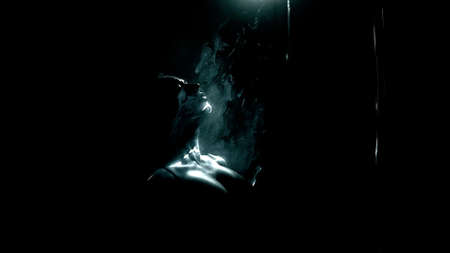 The girl passes through the laser with her head. Black background, lots of smoke