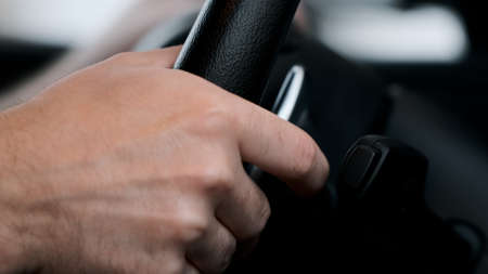 Man shifts gears using the paddles on the steering wheelの写真素材