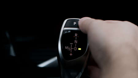 Man shifts gears with joystick with one handの写真素材