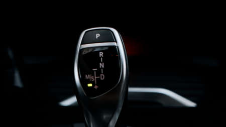 Man shifts gears with joystick with one handの写真素材