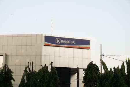 Surakarta, Indonesia - December 20, 2021: An office building of Bank Rakyat Indonesia (BRI) located in the city of Surakarta that stands majestically with blue skies. Banks are state owned.のeditorial素材