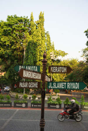 Surakarta, Indonesia - December 23, 2021: A signpost in the Solo city area that shows tourist directions in Surakarta. Beautiful solo city streetsのeditorial素材