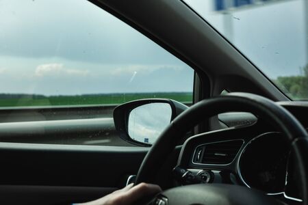 The man is driving. Beautiful nature from the car window.の写真素材