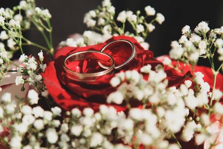 Wedding rings close-up on a bouquet of brides, roses. Red Rose.Happy wedding dayの写真素材