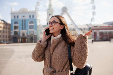Outdoor video conference. Portrait of a beautiful woman.の写真素材