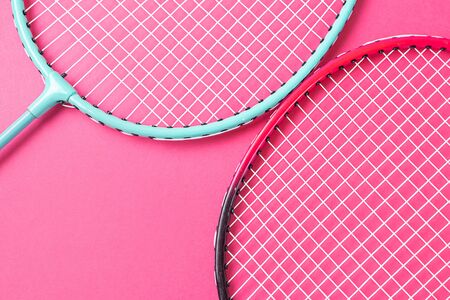 Badminton rackets on a bright pink background. Inventory concept for amateur sports. Minimalism.の写真素材