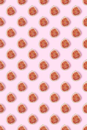 Slices of figs on a pastel pink background. Vegetarian concept. Creative image, minimalism, top...
