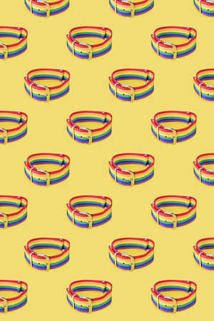 Lgbt bracelet on yellow background, pattern. The concept of sexual tolerance, stop homophobia,...