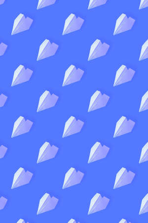 Pattern from white paper airplanes on a blue background. Creative concept of travel, flights.の写真素材