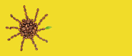 Coffee beans are laid out in the shape of sun on a yellow background. Creative morning concept for...