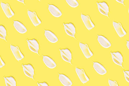 Cosmetic cream close-up. The concept of cosmetic products, skin and hair care, beauty and health. Background image in trendy yellow.の写真素材