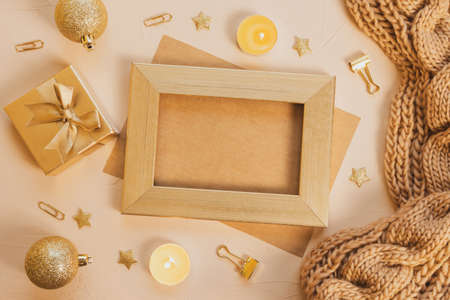 Cozy home flat lay: white cup with coffee, golden photo frame with empty space inside, chunky knit...