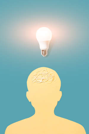 Silhouette of a human head and a lamp above it. The concept of psychology, ideas, creativity.