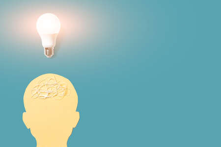 Silhouette of a human head and a lamp above it. The concept of psychology, ideas, creativity. Copyspace.の写真素材