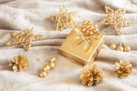 New Year's still life in golden and gray shades. Frame, stars, cones and berries are painted with golden paint. Stylish concept of christmas, celebration. Top view, minimalism, copy space.の写真素材