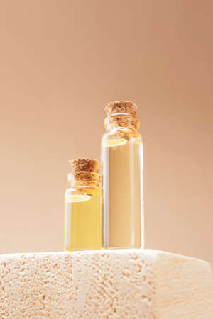 Modern apothecary. Natural essential oil in glass bottles on a wooden podium. The concept of organic essences, natural products for beauty and health.の写真素材