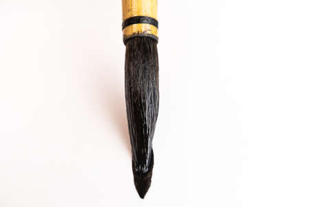 Chinese art brush ink on white paper. The concept of tools for painting, teaching drawing. Macro...