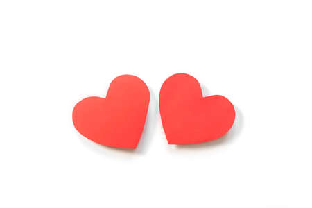Two red paper hearts on a white background. Concept of romance, love, valentine's day. Minimalism, copy space, art paper.の写真素材