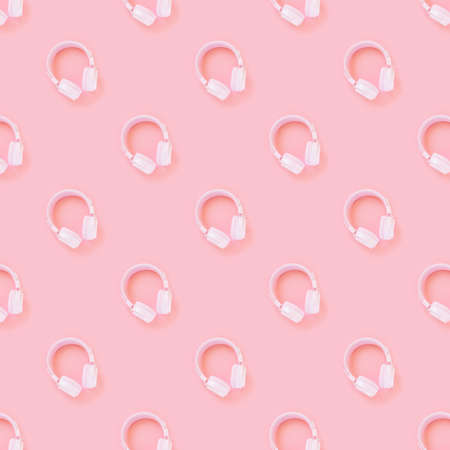 Pink headphones on a pink background. Pattern. Concept for music, podcasts, audiobooks. Top view, copy space.の写真素材