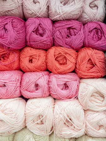 Skeins of red and pink thread for needlework close-up. Background image, sewing, embroidery, handmade, hobby, DIY concept.の写真素材